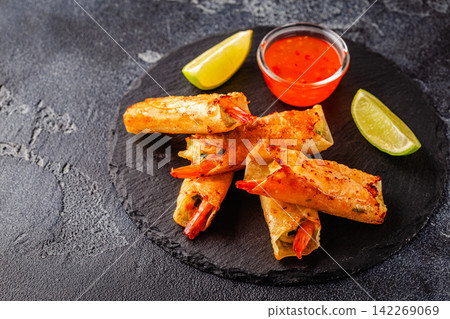 Fried spring rolls with shrimps served with sauce and lime Fried spring rolls with shrimps served with sauce and lime 142269069
