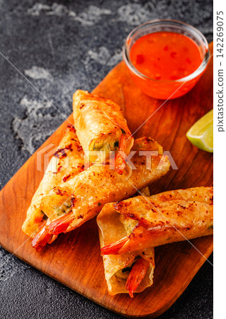 Fried spring rolls with shrimps served with sauce and lime Fried spring rolls with shrimps served with sauce and lime 142269075