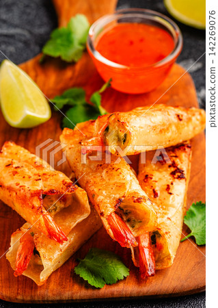 Fried spring rolls with shrimps served with sauce and lime Fried spring rolls with shrimps served with sauce and lime 142269076