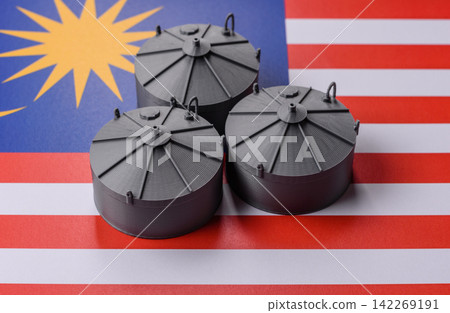 Liquefied gas storage tanks set against the Malaysian flag, concept of supply and distribution Liquefied gas storage tanks set against the Malaysian flag, concept of supply and distribution 142269191