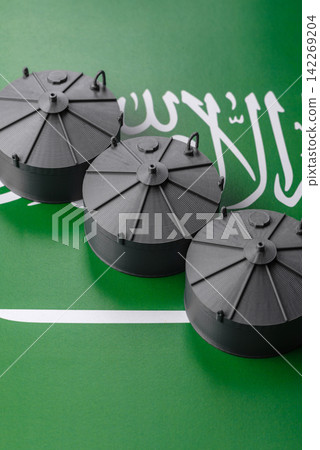 Liquefied gas storage tanks set against the Saudi Arabian flag, concept of supply and distribution Liquefied gas storage tanks set against the Saudi Arabian flag, concept of supply and distribution 142269204