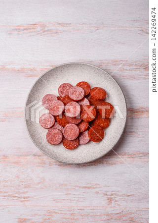 Slices of smoked pepperoni or salami for making homemade pizza. Sliced pepperoni Slices of smoked pepperoni or salami for making homemade pizza. Sliced pepperoni 142269474