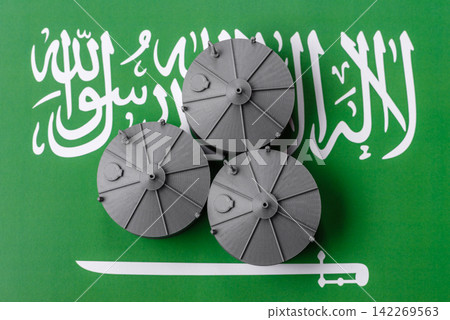 Liquefied gas storage tanks set against the Saudi Arabian flag, concept of supply and distribution Liquefied gas storage tanks set against the Saudi Arabian flag, concept of supply and distribution 142269563