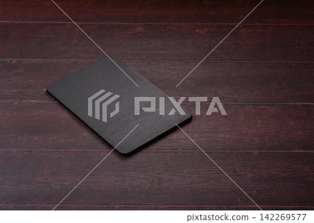 An empty black slate kitchen board for food preparation. An empty slate board serving An empty black slate kitchen board for food preparation. An empty slate board serving 142269577