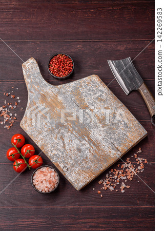 A square wooden cutting board for home food preparation. A wooden cutting board 142269583