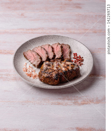 Grilled beef or pork steak seasoned with salt and allspice. Grilled steak Grilled beef or pork steak seasoned with salt and allspice. Grilled steak 142269713