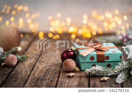 Teal Polka Dot Gift Box with Brown Ribbon on Wood Teal Polka Dot Gift Box with Brown Ribbon on Wood 142270518