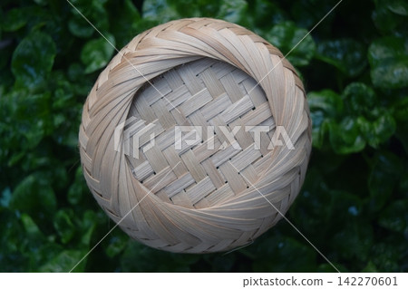 Woven Bamboo Pattern on green leaf Background. Woven Bamboo Pattern on green leaf Background. 142270601