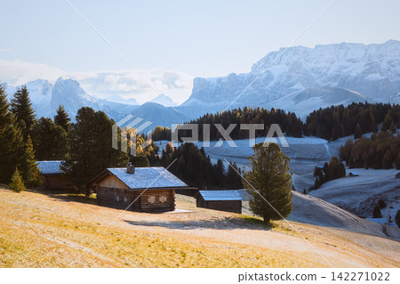 Traditional mountain huts surrounded by frosty meadows on Alpe di Siusi Traditional mountain huts surrounded by frosty meadows on Alpe di Siusi 142271022