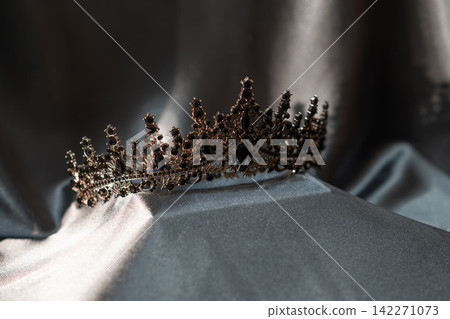Black Royal Crown with Dramatic Lighting on Dark Gray Background. Luxury and Power Black Royal Crown with Dramatic Lighting on Dark Gray Background. Luxury and Power 142271073