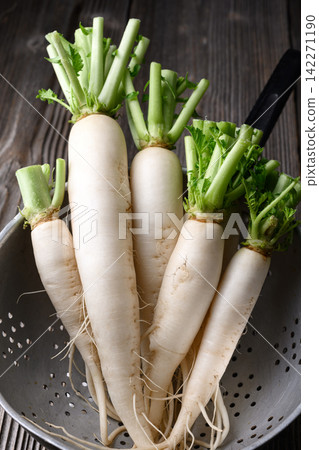 Fresh daikon radish in metal colander Fresh daikon radish in metal colander 142271190