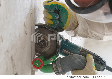 Electrician skillfully cutting electrical wiring during construction work Electrician skillfully cutting electrical wiring during construction work 142271596