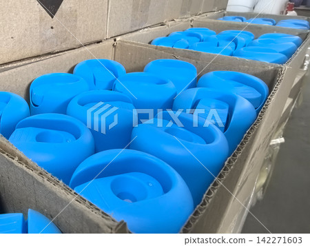 Colorful blue items stacked in a cardboard box ready for use Colorful blue items stacked in a cardboard box ready for use 142271603