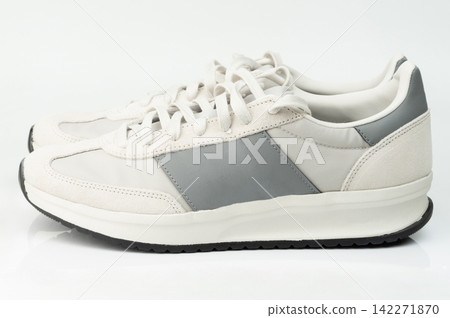 Casual sneakers displayed on a plain white surface Casual sneakers displayed on a plain white surface 142271870