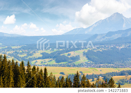 mountain landscape of Poland in late summertime. wonderful view of High Tatra ridge above Zakopane village valley. vacation place in Europe mountain landscape of Poland in late summertime. wonderful view of High Tatra ridge above Zakopane village valley. vacation place in Europe 142271883
