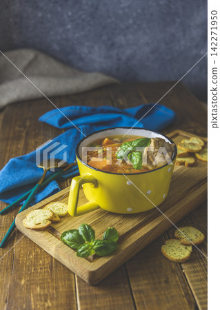Homemade chicken vegetable soup with carrots and sweet potatoes, on wooden board over rustic wooden table background. Shallow depth of field. Homemade chicken vegetable soup with carrots and sweet potatoes, on wooden board over rustic wooden table background. Shallow depth of field. 142271950