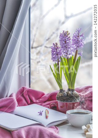 Early spring still life scene. Cup of coffee and marshmallow, opened notebook, pink plaid and candles on windowsill. Cozy Easter, vintage feminine styled photo 142272035