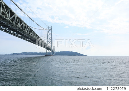 A magnificent suspension bridge and a calm sea – a refreshing holiday scene. A magnificent suspension bridge and a calm sea – a refreshing holiday scene. 142272059