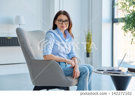 Confident mature businesswoman in glasses looking at camera in office 142272102