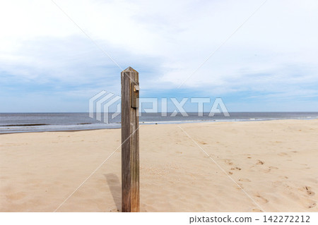 Wooden post with outdoor light on North Sea beach in Wijk aan Zee Netherlands Wooden post with outdoor light on North Sea beach in Wijk aan Zee Netherlands 142272212
