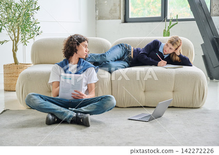 Two teenage students looking at each other at home 142272226