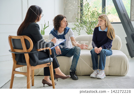 Teenage social worker talking to youth at session Teenage social worker talking to youth at session 142272228