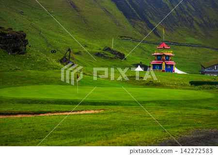 Colorful Buddhist Temple on Lush Green Golf Course in Iceland Colorful Buddhist Temple on Lush Green Golf Course in Iceland 142272583