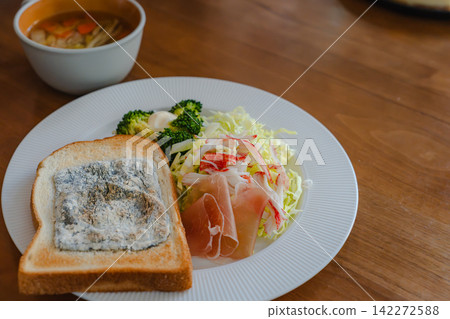 A beautifully presented breakfast consisting of toast, salad, and soup. A beautifully presented breakfast consisting of toast, salad, and soup. 142272588