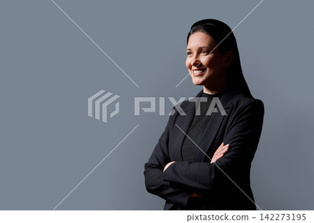 Confident business woman standing with arms crossed on gray background 142273195