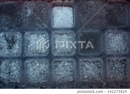 Close up of an ice cube tray filled with frozen square cubes Close up of an ice cube tray filled with frozen square cubes 142273824