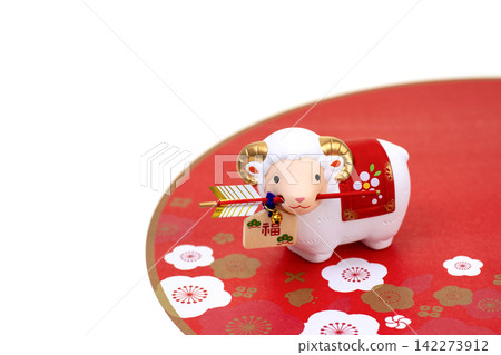 New Year's greeting card design for the Year of the Sheep: A cute white sheep holding a protective arrow in its mouth and plum blossoms. New Year's greeting card design for the Year of the Sheep: A cute white sheep holding a protective arrow in its mouth and plum blossoms. 142273912