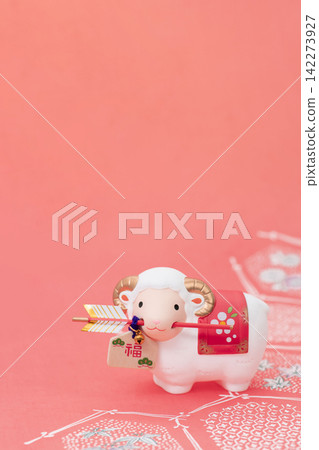 New Year's greeting card material for the Year of the Sheep: A cute white sheep holding a protective arrow in its mouth against a Japanese pattern background. New Year's greeting card material for the Year of the Sheep: A cute white sheep holding a protective arrow in its mouth against a Japanese pattern background. 142273927