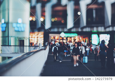 A blurred cityscape and pedestrians. A blurred cityscape and pedestrians. 142273979