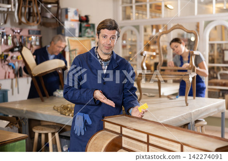 Male furniture workshop worker designing vintage chest of drawers Male furniture workshop worker designing vintage chest of drawers 142274091