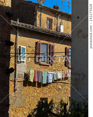 Volterra old town rustic building with laundry drying Volterra old town rustic building with laundry drying 142275026