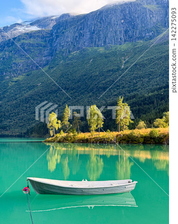 White boat floating on turquoise loen lake in stryn, norway White boat floating on turquoise loen lake in stryn, norway 142275093