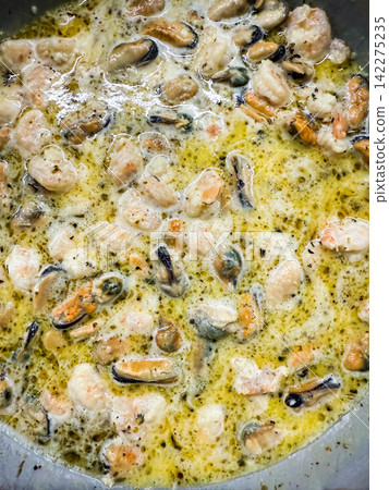 Mussels and shrimp cooking in creamy sauce Mussels and shrimp cooking in creamy sauce 142275235