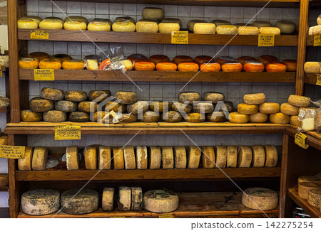 Artisan pecorino cheese wheels aging on wooden shelves Artisan pecorino cheese wheels aging on wooden shelves 142275254