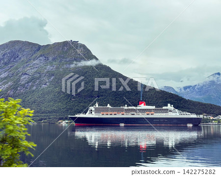 Cruise ship sailing norwegian fjord under cloudy sky Cruise ship sailing norwegian fjord under cloudy sky 142275282
