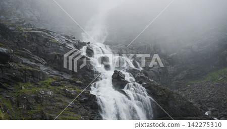 Stigfossen waterfall flowing down misty mountains in norway Stigfossen waterfall flowing down misty mountains in norway 142275310