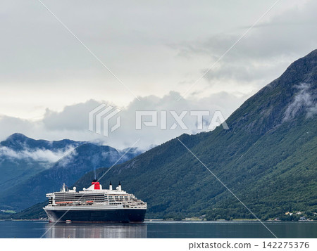 Queen elizabeth cruise ship navigating norwegian fjord mountains Queen elizabeth cruise ship navigating norwegian fjord mountains 142275376