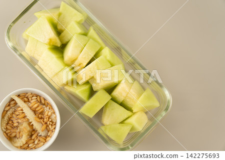 The juicy flesh and seed area of a cut Miura melon The juicy flesh and seed area of a cut Miura melon 142275693