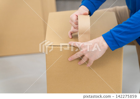 A young man working in the moving industry; lifestyle image A young man working in the moving industry; lifestyle image 142275859