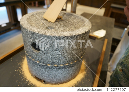 Stone milling to grind soybeans into flour Stone milling to grind soybeans into flour 142277307