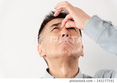A senior man in casual clothes standing – a lifestyle image. A senior man in casual clothes standing – a lifestyle image. 142277591