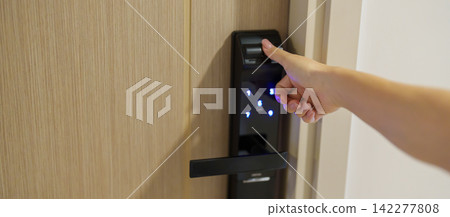 Hand using fingerprint scan for smart digital door lock while open or close the door at home or apartment. NFC Technology, keycard, PIN number, smartphone and contactless lifestyle concepts Hand using fingerprint scan for smart digital door lock while open or close the door at home or apartment. NFC Technology, keycard, PIN number, smartphone and contactless lifestyle concepts 142277808