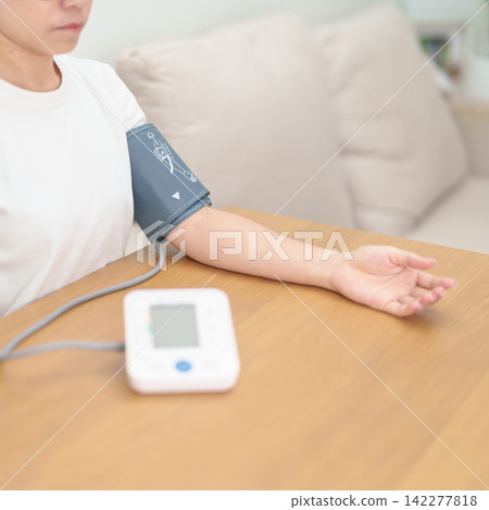 woman checking Blood pressure by Blood pressure monitor with Cuff. Systolic, SYS, Diastolic, DIA, Pulse, Hypertension, Hypotension, Heart rate, Cardiovascular Disease and May World hypertension day woman checking Blood pressure by Blood pressure monitor with Cuff. Systolic, SYS, Diastolic, DIA, Pulse, Hypertension, Hypotension, Heart rate, Cardiovascular Disease and May World hypertension day 142277818