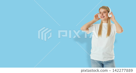 Happy woman listens to music using wireless headphones Happy woman listens to music using wireless headphones 142277889