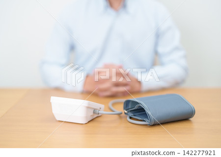 Man checking Blood pressure by Blood pressure monitor with Cuff. Systolic, SYS, Diastolic, DIA, Pulse, Hypertension, Hypotension, Heart rate, Cardiovascular Disease and May World hypertension day Man checking Blood pressure by Blood pressure monitor with Cuff. Systolic, SYS, Diastolic, DIA, Pulse, Hypertension, Hypotension, Heart rate, Cardiovascular Disease and May World hypertension day 142277921