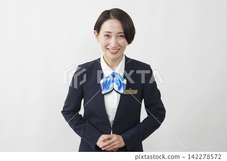 A female staff member in her 40s smiles and greets the audience against a white background. A female staff member in her 40s smiles and greets the audience against a white background. 142278572